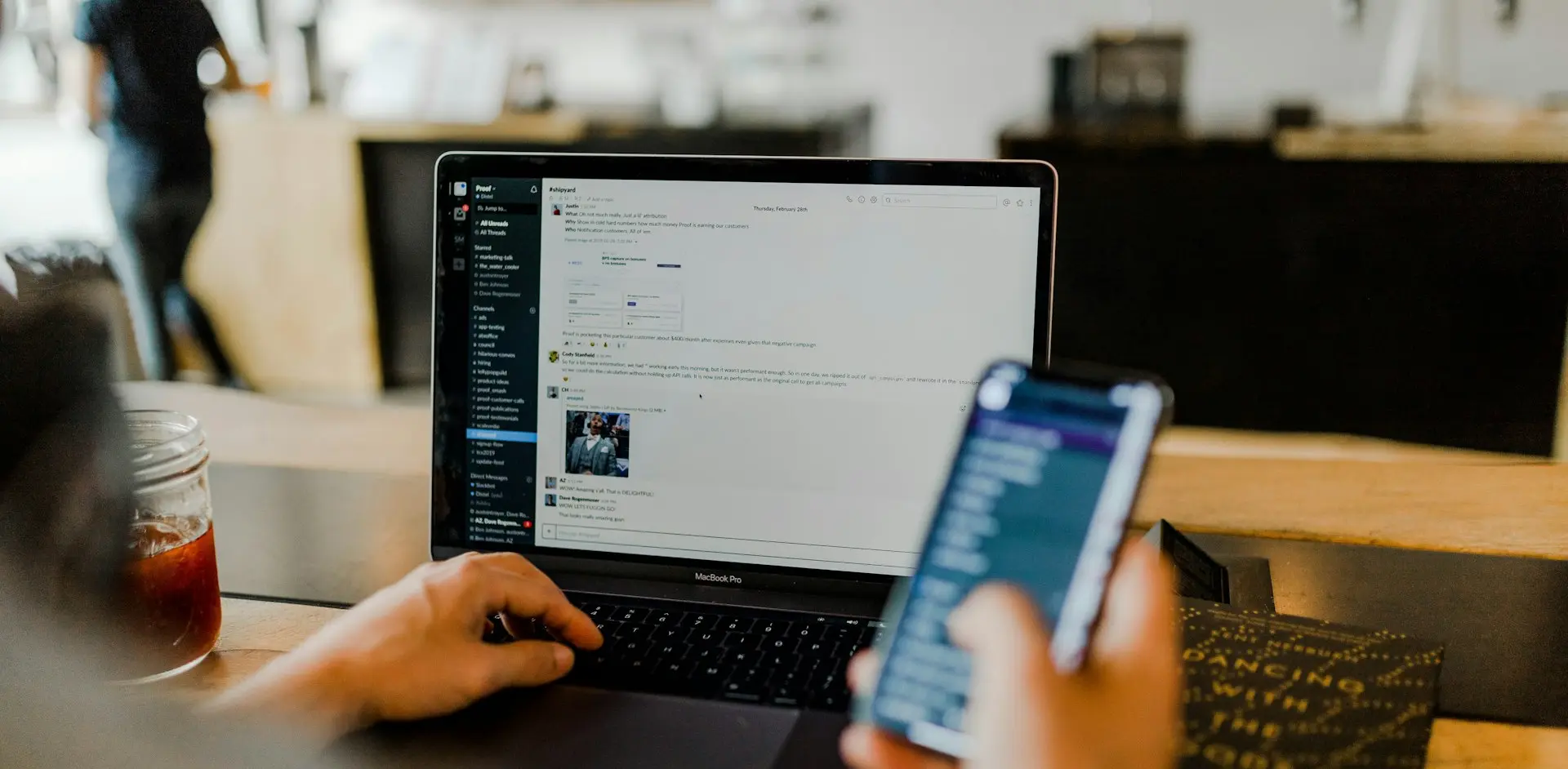 person using phone and laptop